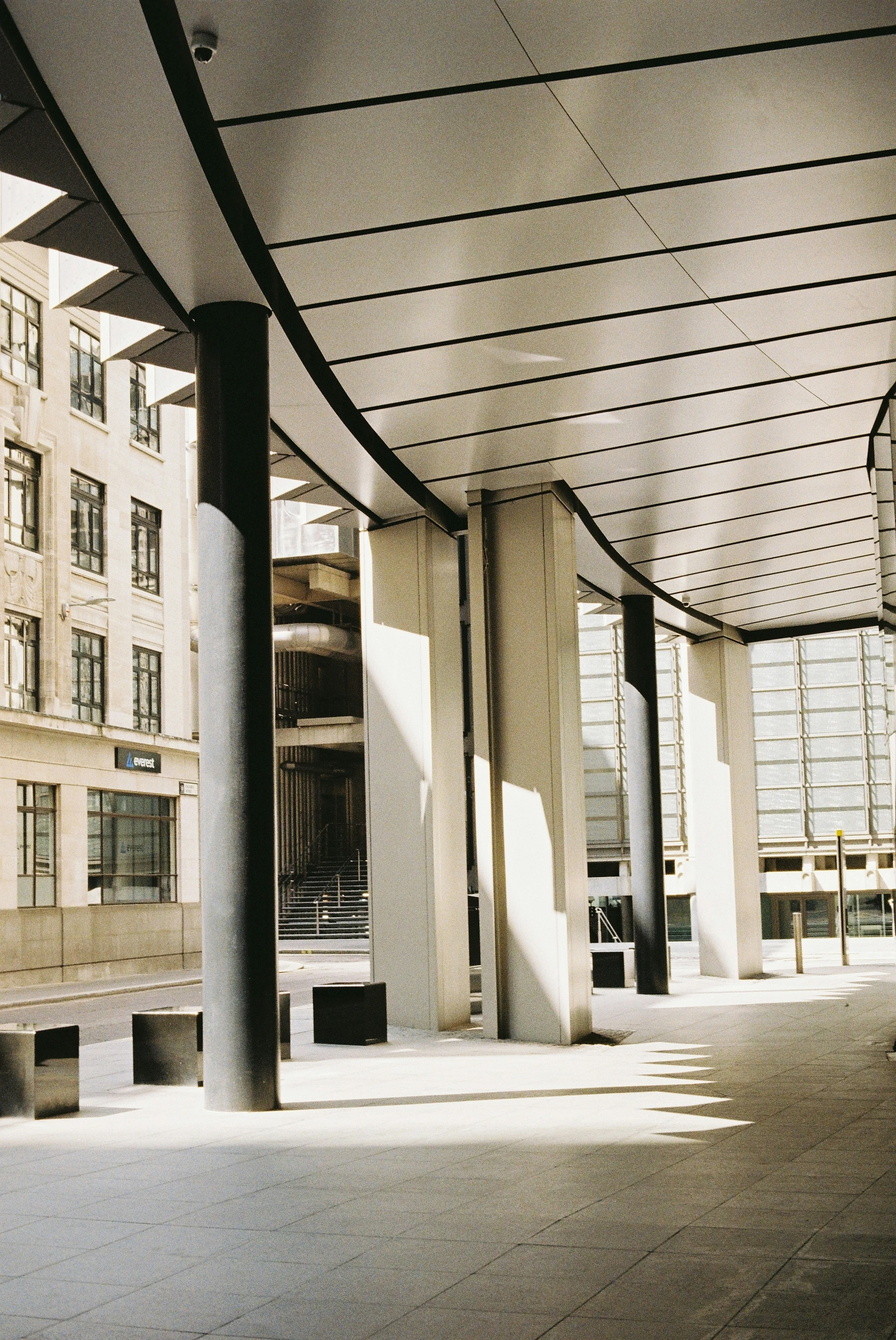 A stylish, empty arcade in a financial district — clean lines, restrained light, suggesting the regulated environments where tax and residency questions live.