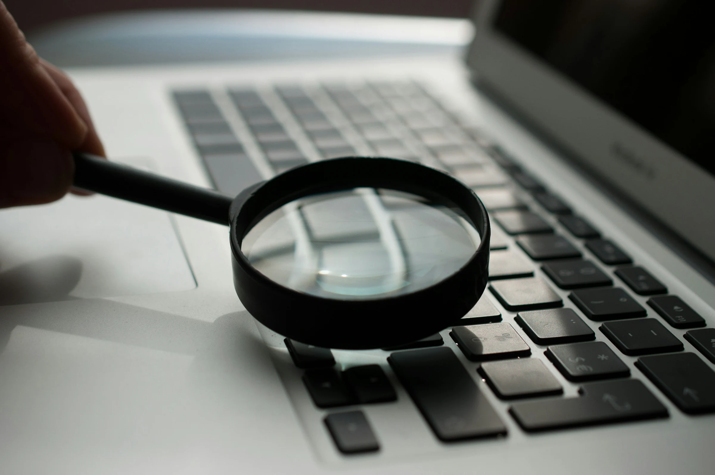 A magnifying glass resting on a document — the scrutiny that defines a serious due diligence review.