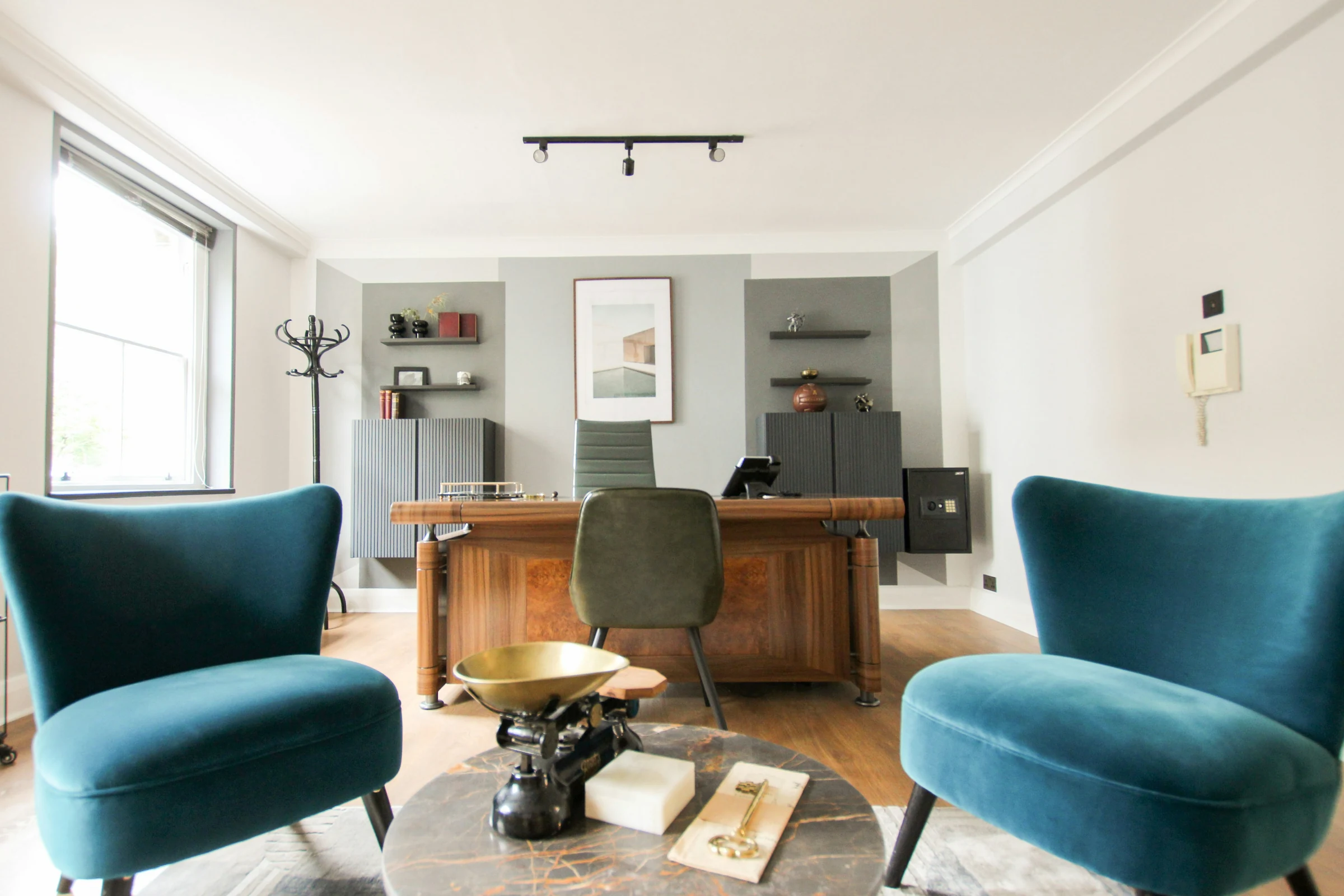 Two chairs facing each other in a discreet senior office — the considered, private nature of a serious advisory conversation.