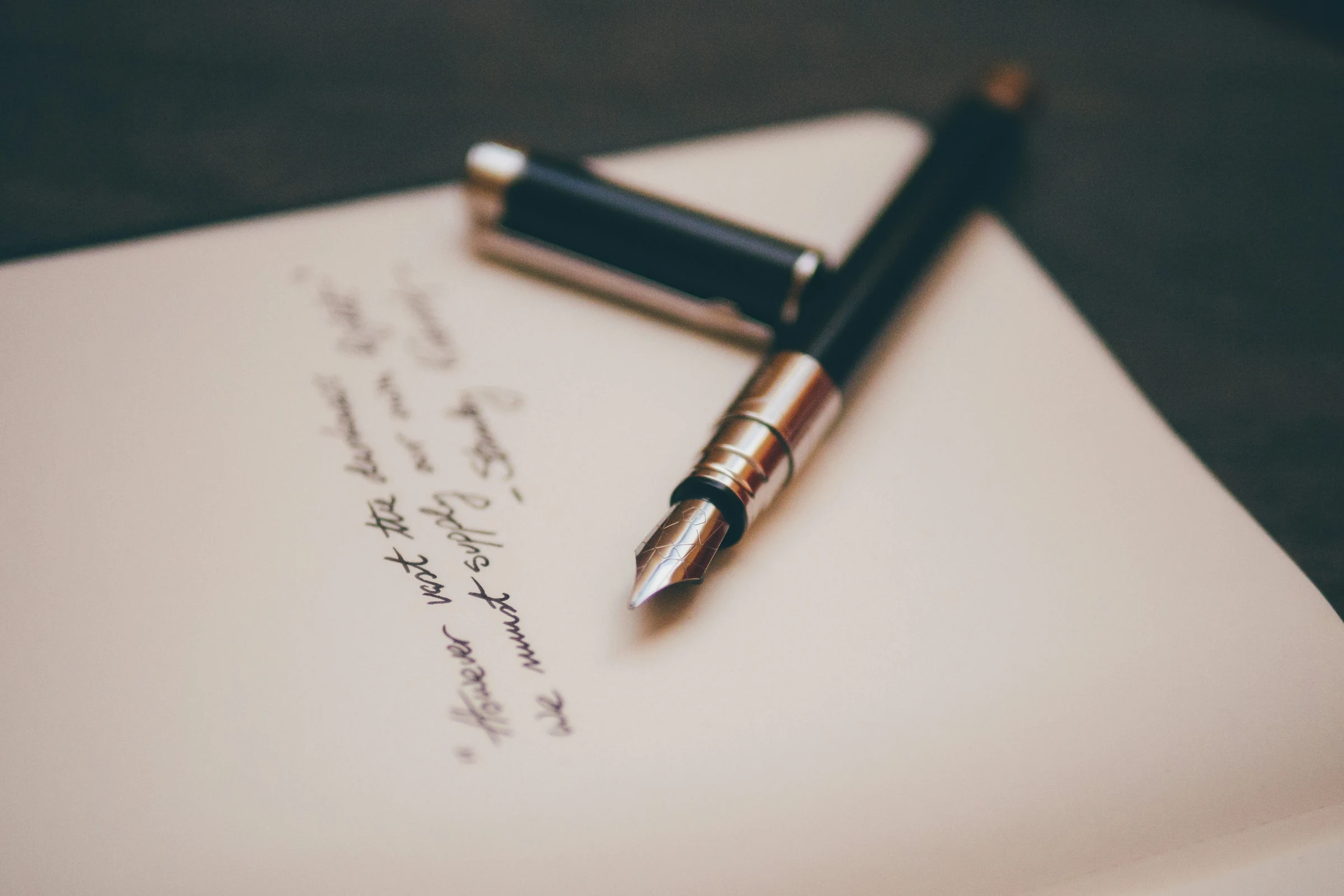 An open journal beside a fountain pen on a clean desk — the visual register of considered decision-making.